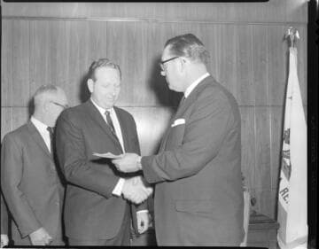 Executives posed exchanging checks