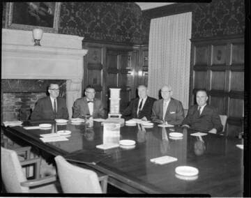 Jack Horton with 4 other executives seated at conference table in the old General Office board room at 5th & Grand