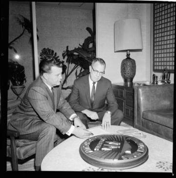 Men inspecting Medallion Home display plates