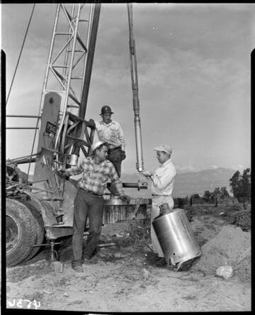 Men with drill rig on truck taking core samples?