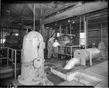 Three men in a pumping plant