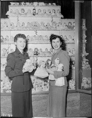 Two ladies with Christmas doll display