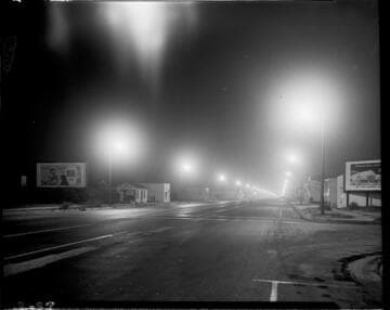 street during the night with street lighting down sides