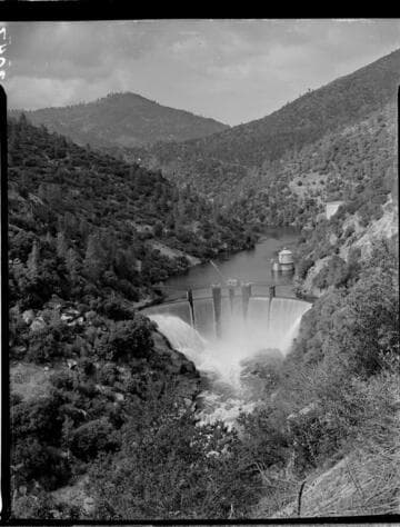 Establishing shot of Big Creek Dam 6 Spilling