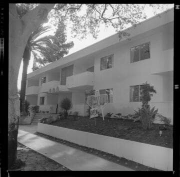Men touring the opening of an apartment complex