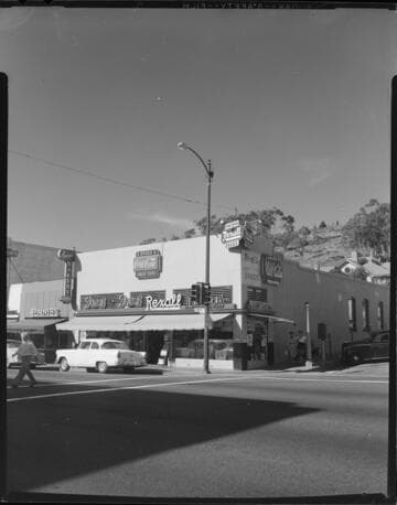 Traffic light on corner by Franz & Franz Rexall Drugs