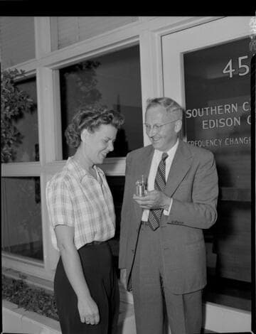 Woman receiving a bowling trophy in front of a Frequency Change office
