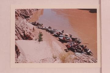 The seven boats of the Marston-Disney fleet moored below the skeleton above Paradise Canyon.  Upper left is the "Emma Dean", the "Rattlesnake", the "Cactus", the "Paradox", the camera boat and the "Bootoo"