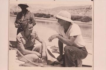 Doris Nevills and Norm Nevills posed during the run of 1940 from Green River, Wyoming, to Boulder City.  Charley Larabee is in the background