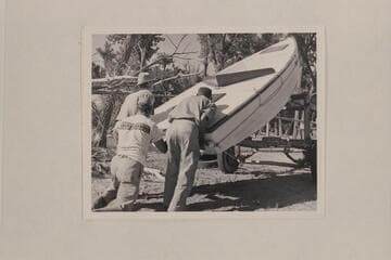 A. K. Reynolds, Lug Larsen and Georgie Reynolds unloading the "Galloway" at Carr's Landing in Brown's Hole