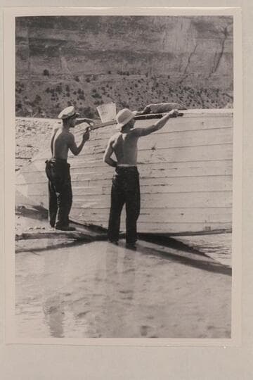 Buzz Holmstrom and Norm Nevills repairing one of the Nevills' skiffs at Pat's Hole