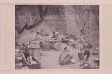 Breakfast at camp above mouth of Clear Creek.  At the table are Ian Campbell, John Stark, Bob Sharp, Merrill Spencer.  At the fire are Owen Clark and Frank Dodge