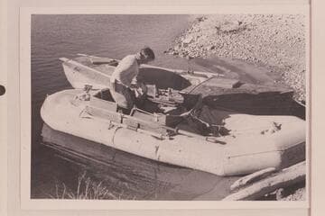 The rubber raft "Charlie" and the skiff "Julius F." at end of run from Wyoming to Lake Mead.  Burg stands in the raft