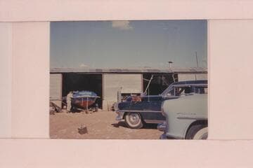 The "CACTUS" in the shop at Fredonia.  Ed I'Anson leans on the boat and Rod Sanderson is beyond him