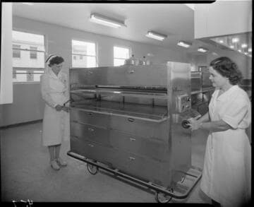Nurse and a lady with what appears to be an electric food transport cart